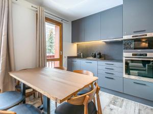 a kitchen with a wooden table and chairs at Appartement Val-d'Isère, 3 pièces, 5 personnes - FR-1-519-22 in Val-d'Isère