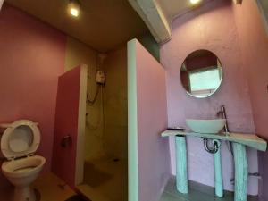 a bathroom with a sink and a toilet and a mirror at Pingplalee Resort in Sai Yok