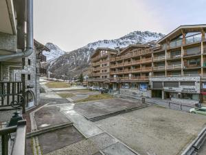 a view from a balcony of a resort with mountains at Appartement Val-d'Isère, 3 pièces, 6 personnes - FR-1-519-31 in Val-d'Isère