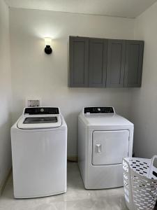 a kitchen with a stove and a washer and dryer at New! Bluestone Getaway in Christiansted USVI ! in Christiansted