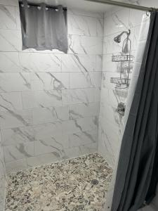 a bathroom with a shower with white tiles at New! Bluestone Getaway in Christiansted USVI ! in Christiansted