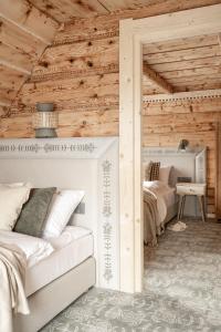 a bedroom with a bed and a wooden ceiling at Willa Halna in Zakopane