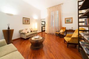 a living room with a couch and a table at Zamboni Suite in Bologna