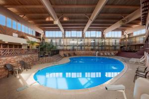 a large swimming pool in a large building with windows at Quality Inn in Chickasha