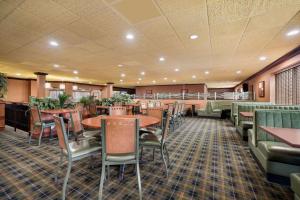 a dining room with tables and chairs and tablesktop at Quality Inn and Suites Fairgrounds - Syracuse in Liverpool