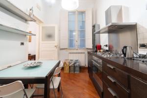 a kitchen with a counter top and a table at Zamboni Suite in Bologna