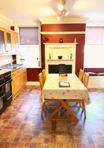 a kitchen with a table with a laptop on it at The Georgian Apartment in Gosport