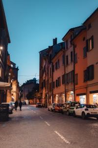 a city street with cars parked on the street at Zamboni Suite in Bologna