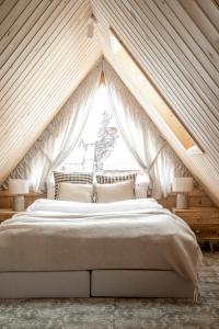 a bedroom with a large bed in a attic at Willa Halna in Zakopane