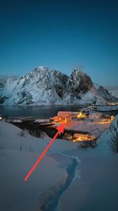 a view of a town in the snow at night at White House - Panoramic View in Reine +47 photos