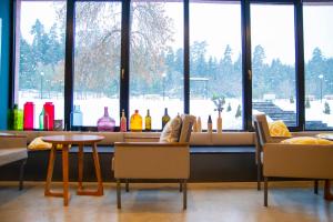 a restaurant with a table and chairs in front of a window at Mountain Resort Gantiadi in Borjomi