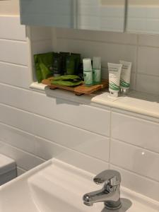 a bathroom with a sink and a mirror and a sink at Shepparton Lakeside Serviced Apartment in Shepparton