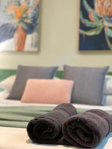 a group of towels sitting on top of a bed at Shepparton Lakeside Serviced Apartment in Shepparton