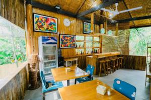 a restaurant with wooden walls and tables and a bar at Vafi Hills Bed And Breakfast in San Isidro