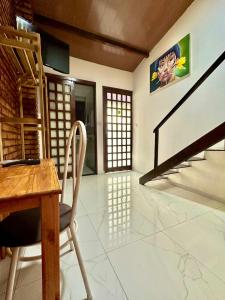 a dining room with a table and chairs and stairs at Pousada HOME BEACH MAR porto das dunas BEACH PARK in Aquiraz