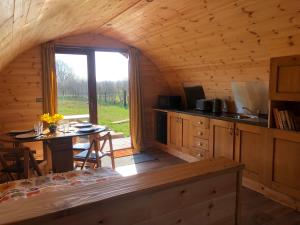 a kitchen and dining room in a log cabin at Manor Farm Stay in Sutton on Sea