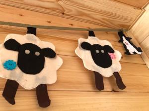 two felt sheep puppets hanging on a table at Manor Farm Stay in Sutton on Sea