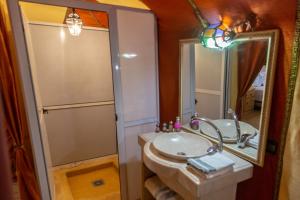 a bathroom with a sink and a mirror at Erg chebbi Dunes Desert Camp in Merzouga