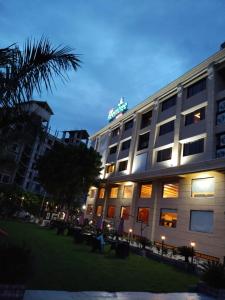 a hotel building with a sign on top of it at Sai Neem Tree Hotel in Shirdi