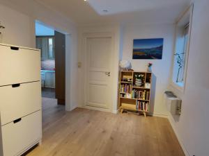 a room with a white door and a book shelf at Fløyen Townhouse in Bergen +13 photos