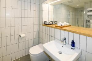 a bathroom with a toilet and a sink and a mirror at The Salt Lodge in Troon +45 photos