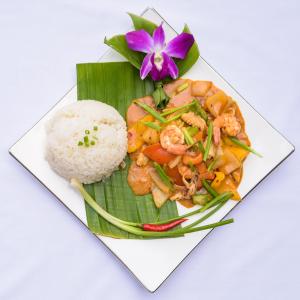 a plate of food with shrimp and rice on a banana leaf at Happy Heng Heang Guesthouse in Siem Reap