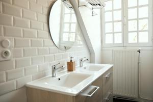a bathroom with a sink and a mirror at La Maison du Gasseau in Saint-Léonard-des-Bois +33 photos
