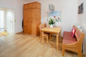 a dining room with a table and chairs at Villa Marie Wohnung 1, Norderney in Norderney +5 photos