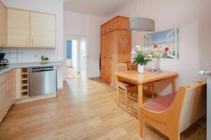 a kitchen with a table and a dining room at Villa Marie Wohnung 1, Norderney in Norderney