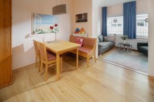 a living room with a table and chairs and a couch at Villa Marie Wohnung 1, Norderney in Norderney