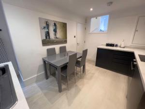 a kitchen and dining room with a table and chairs at The Dragon Pad Boutique Apartment in Royal Tunbridge Wells