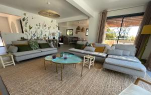 salon z kanapą i stołem w obiekcie Villa Terra Vecchia, 6 ou 12 personnes, vue imprenable, piscine chauffée w mieście Porto-Vecchio