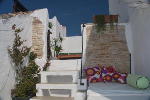 a group of white stairs with a couch on them at Koala Tarifa in Tarifa