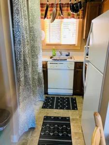 a small kitchen with a sink and a refrigerator at Come feel what it's like to relax at 4900' in Sugar Mountain