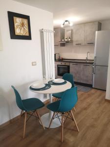 a kitchen with a table and chairs in a room at HomyHome in Civitavecchia