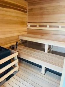 a sauna with wooden walls and benches in a room at Come feel what it's like to relax at 4900' in Sugar Mountain