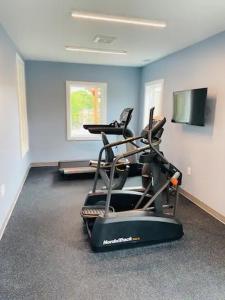a room with a gym with two chairs and a flat screen tv at Come feel what it's like to relax at 4900' in Sugar Mountain