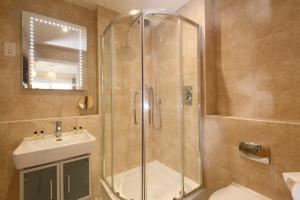 a bathroom with a shower and a sink at The Beach House & Porth Sands Apartments in Newquay +100 photos