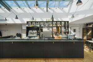 a bar with a large black counter in a room at Maison Nô - Hôtel et Rooftop in Lyon