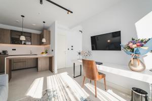 a kitchen and living room with a vase of flowers at Hotel Aurel Coast in Kotor