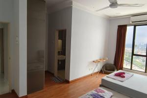 a living room with a couch and a window at Platino, beside Paradigm Shopping Mall, free wi-fi, 4 bedrooms & 3 toilets, up to 12pax in Johor Bahru