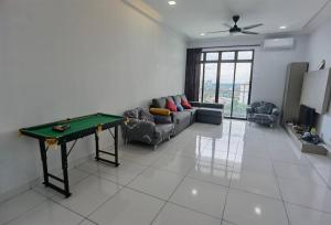 a living room with a ping pong table in it at Platino, beside Paradigm Shopping Mall, free wi-fi, 4 bedrooms & 3 toilets, up to 12pax in Johor Bahru