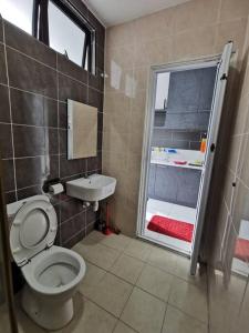 a bathroom with a toilet and a sink at Platino, beside Paradigm Shopping Mall, free wi-fi, 4 bedrooms & 3 toilets, up to 12pax in Johor Bahru