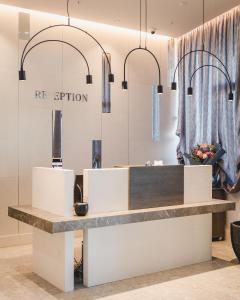 a counter in a store with two pendant lights at Hotel Aurel Coast in Kotor