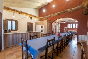 a long dining room with a long table and chairs at CASA RURAL VICENTA 1750 Alojamiento rural, capacidad hasta 30 personas in Albentosa