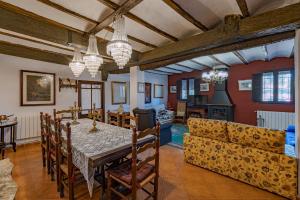 a dining room with a table and a couch at CASA RURAL VICENTA 1750 Alojamiento rural, capacidad hasta 30 personas in Albentosa