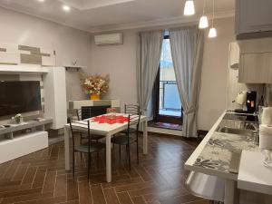 a kitchen and dining room with a table and chairs at Casa Meravigliosa Fonseca in Naples