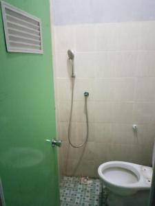 ein Bad mit einer Dusche und einem WC in der Unterkunft pandya Bromo in Pasuruan