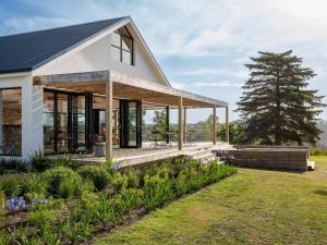 a house with glass walls and a roof at Crags Country Lodge in The Crags