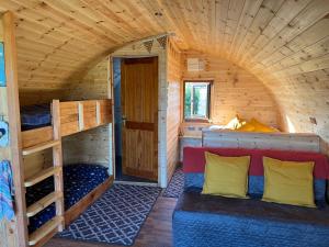 a room with a bed and bunk beds in a cabin at Manor Farm Stay in Sutton on Sea